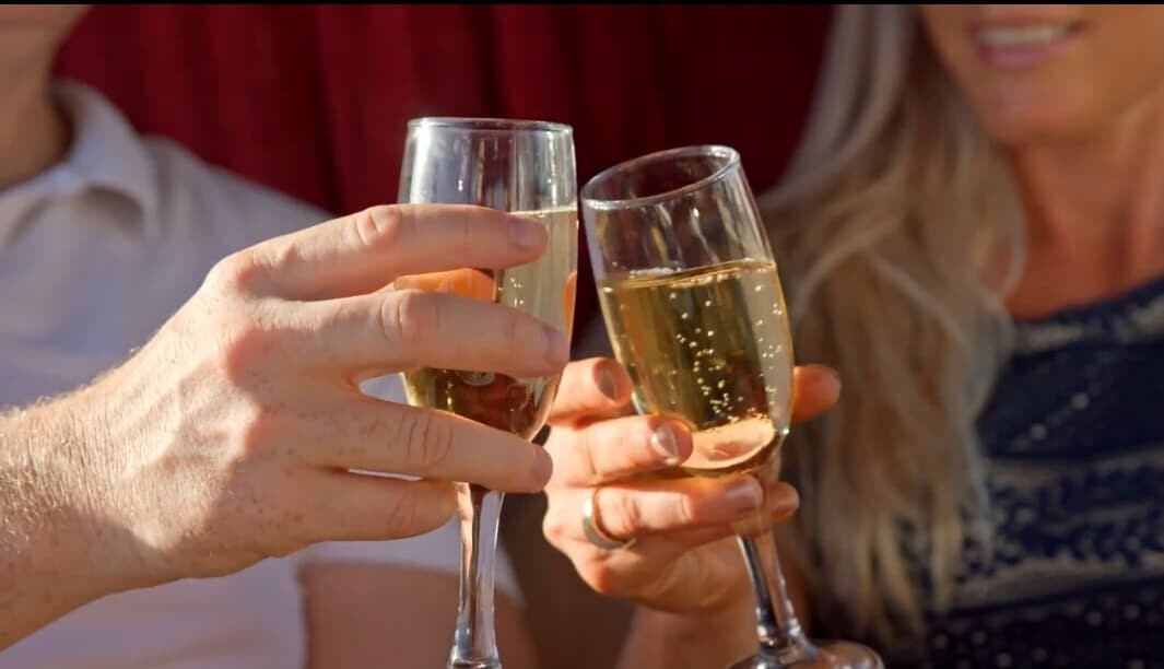Couple toasting with champagne glasses during a romantic moment—one of many memorable Gold Coast date ideas perfect for celebrating love and connection near the Broadwater.